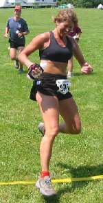 Liz Walker jumps across the finish line